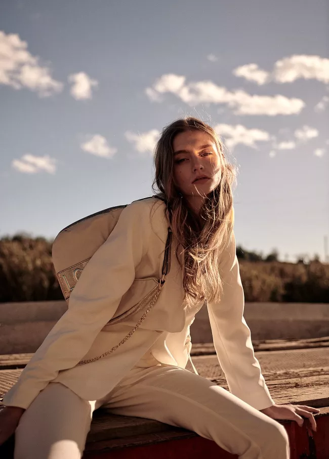 Trousers with golden eyelets details