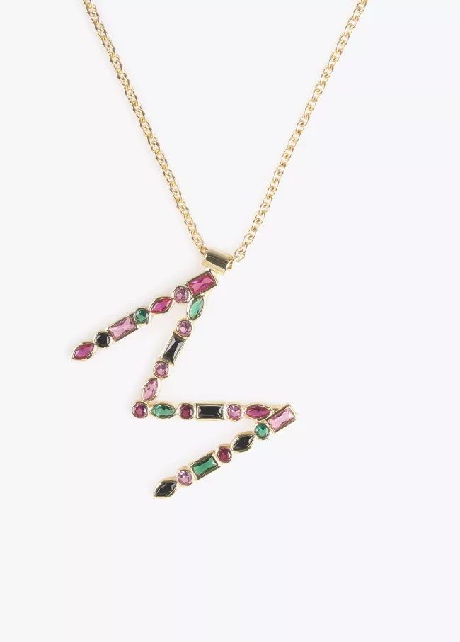 Long gold plated necklace featuring an M
